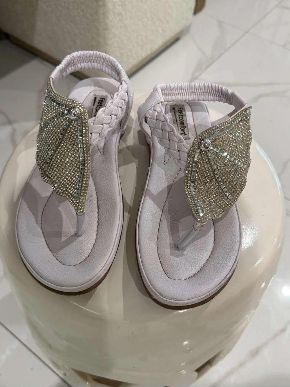 White rhinestone sandals with braided straps.